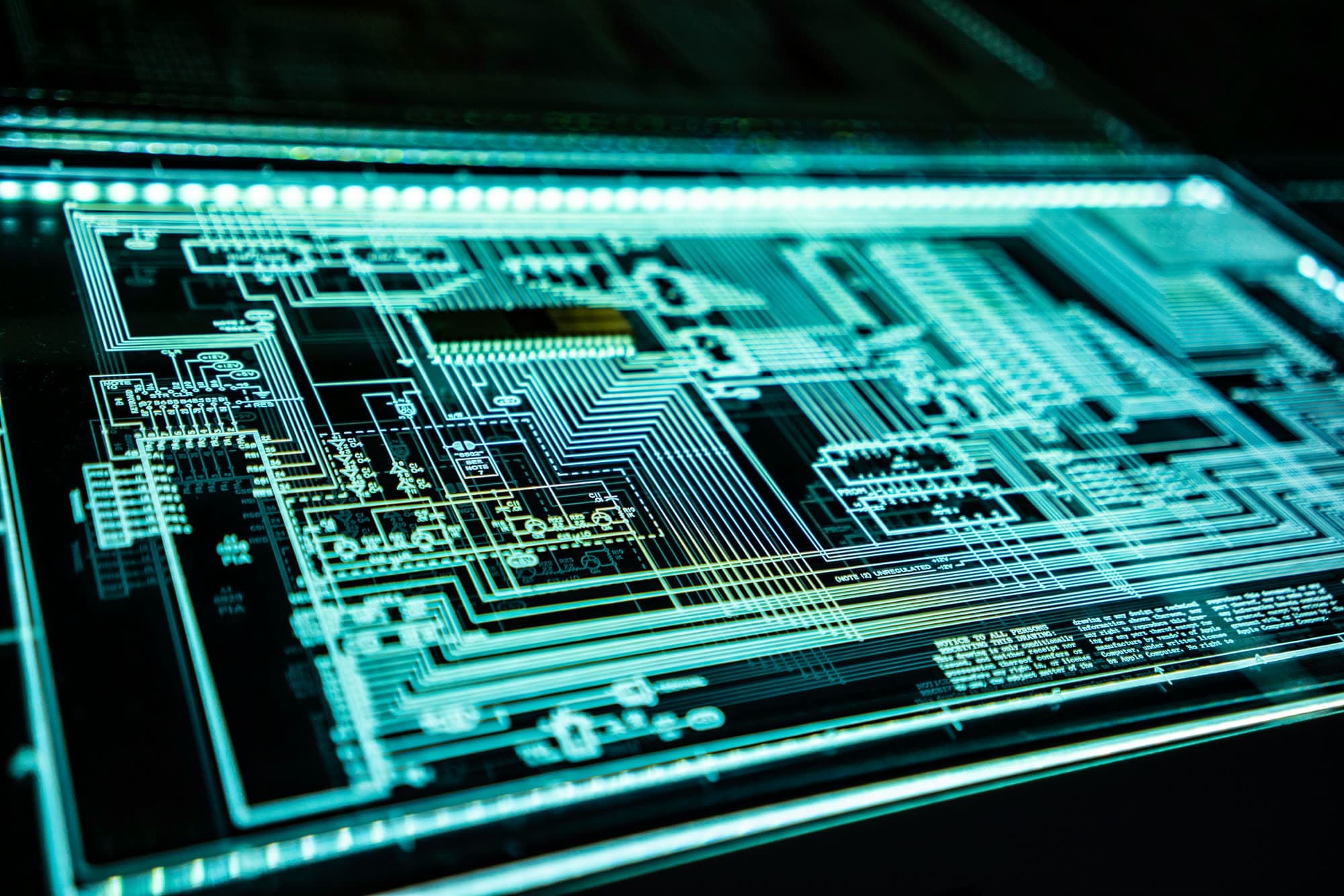 Illuminated electronic circuit schematic on a backlit glass panel